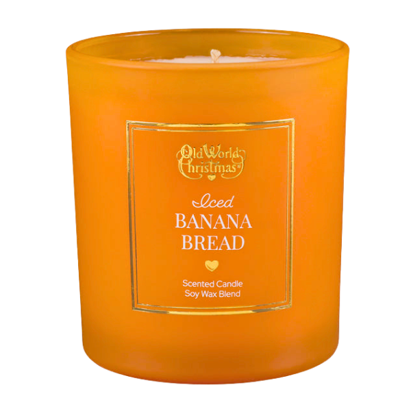 an orange candle sits on an autumnal 