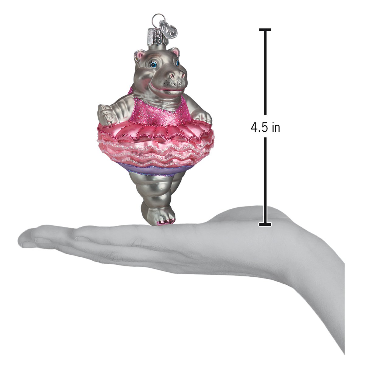 Decorative hippo ornament in a pink dress held in a hand with a measurement label.