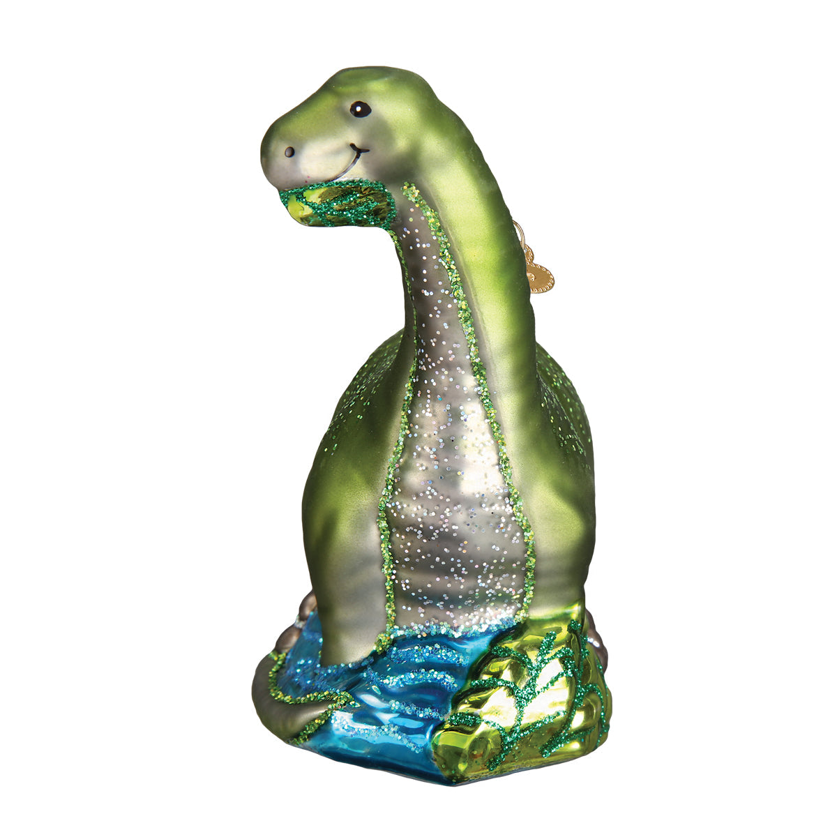 Decorative glass ornament of a green dinosaur on a white background