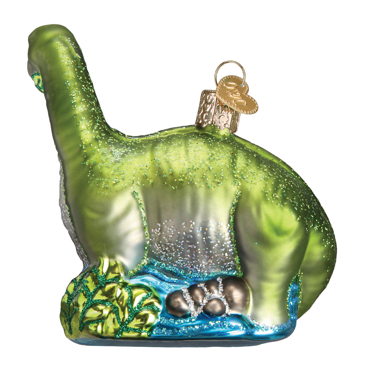 Glass ornament of a green dinosaur with a white background