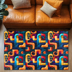 Colorful geometric patterned rug in front of a brown leather sofa.