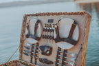 Decorative box with cutlery set on a blurred water background