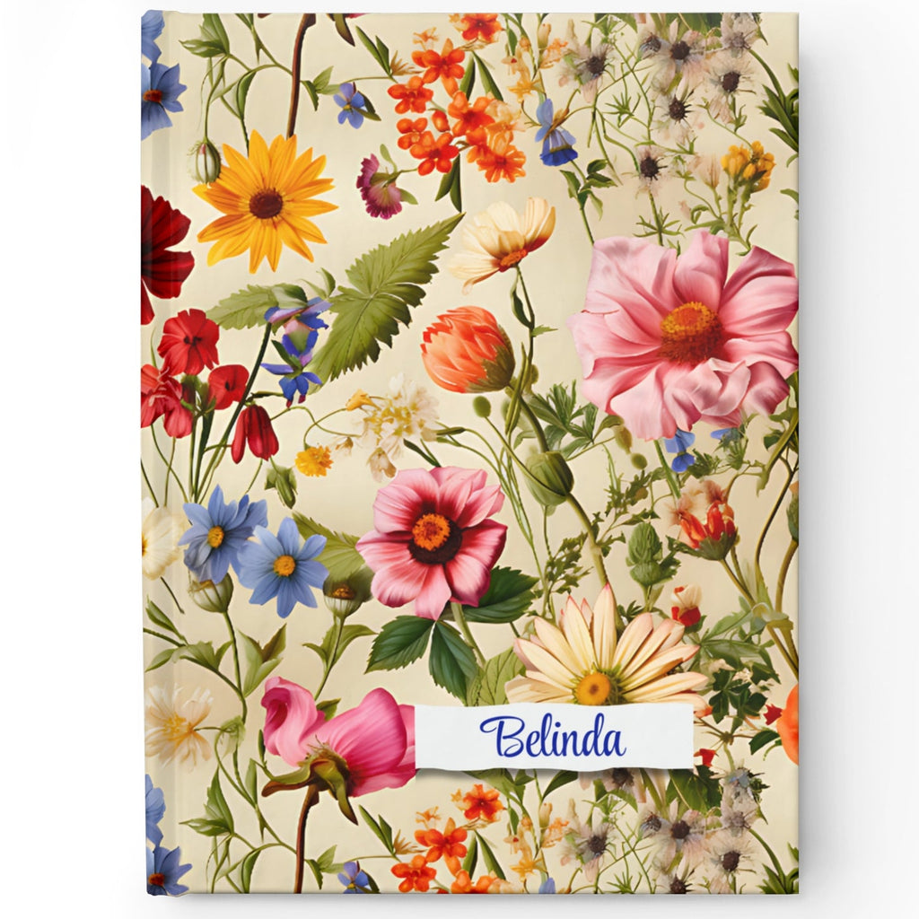 A personalized hardcover journal with a vintage floral design and a custom name 'Olivia' printed on the cover.