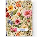 A personalized hardcover journal with a vintage floral design and a custom name 'Olivia' printed on the cover.