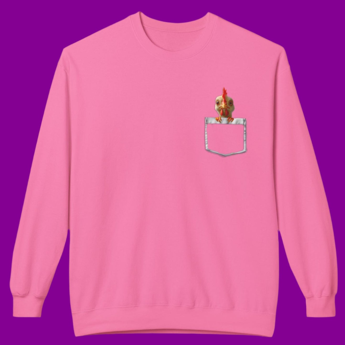 a pink sweatshirt has a printed front pocket with an orange young chicken sticking its head and front claws out of the pocket. Pocket Pals! Only from The Curated Goose