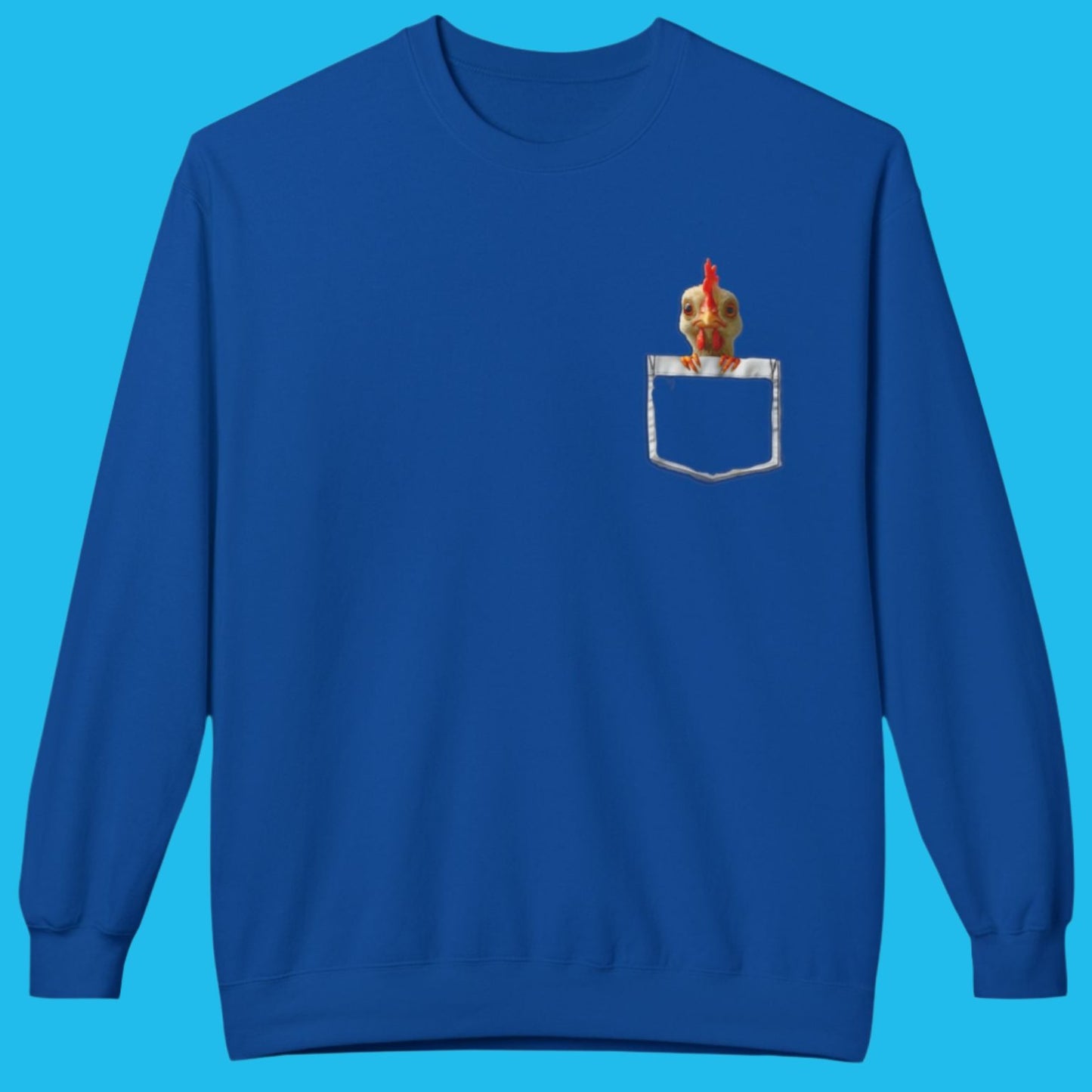 a blue sweatshirt has a printed front pocket with an orange young chicken sticking its head and front claws out of the pocket. Pocket Pals! Only from The Curated Goose