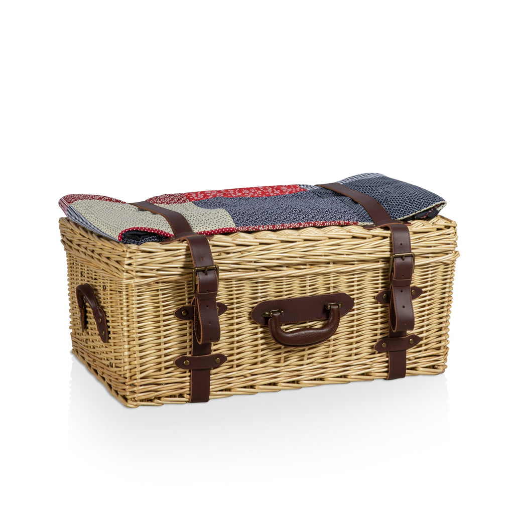 Wicker picnic basket with a patterned cover on a white background