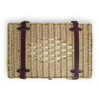 Woven basket with leather straps on a white background