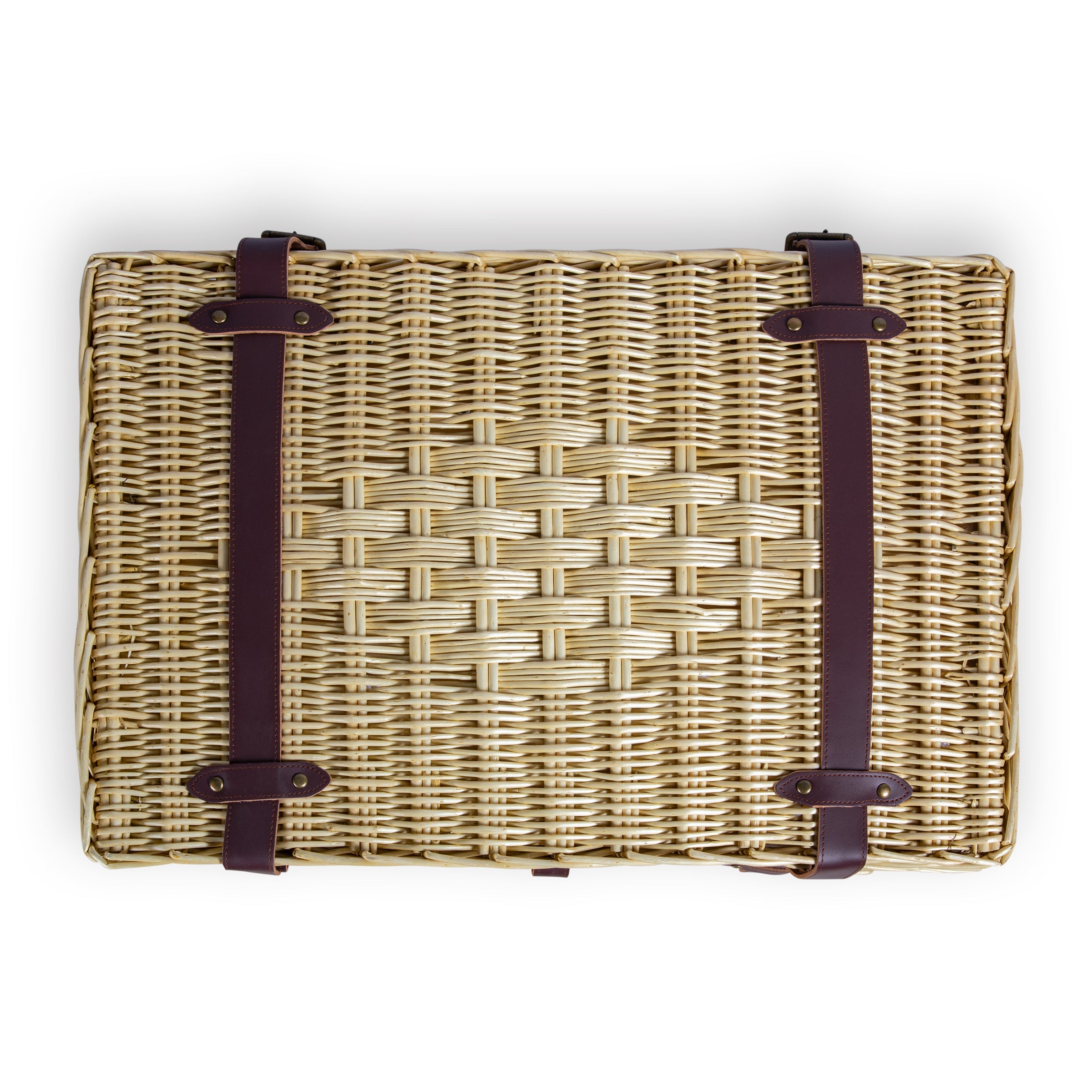 Woven basket with leather straps on a white background