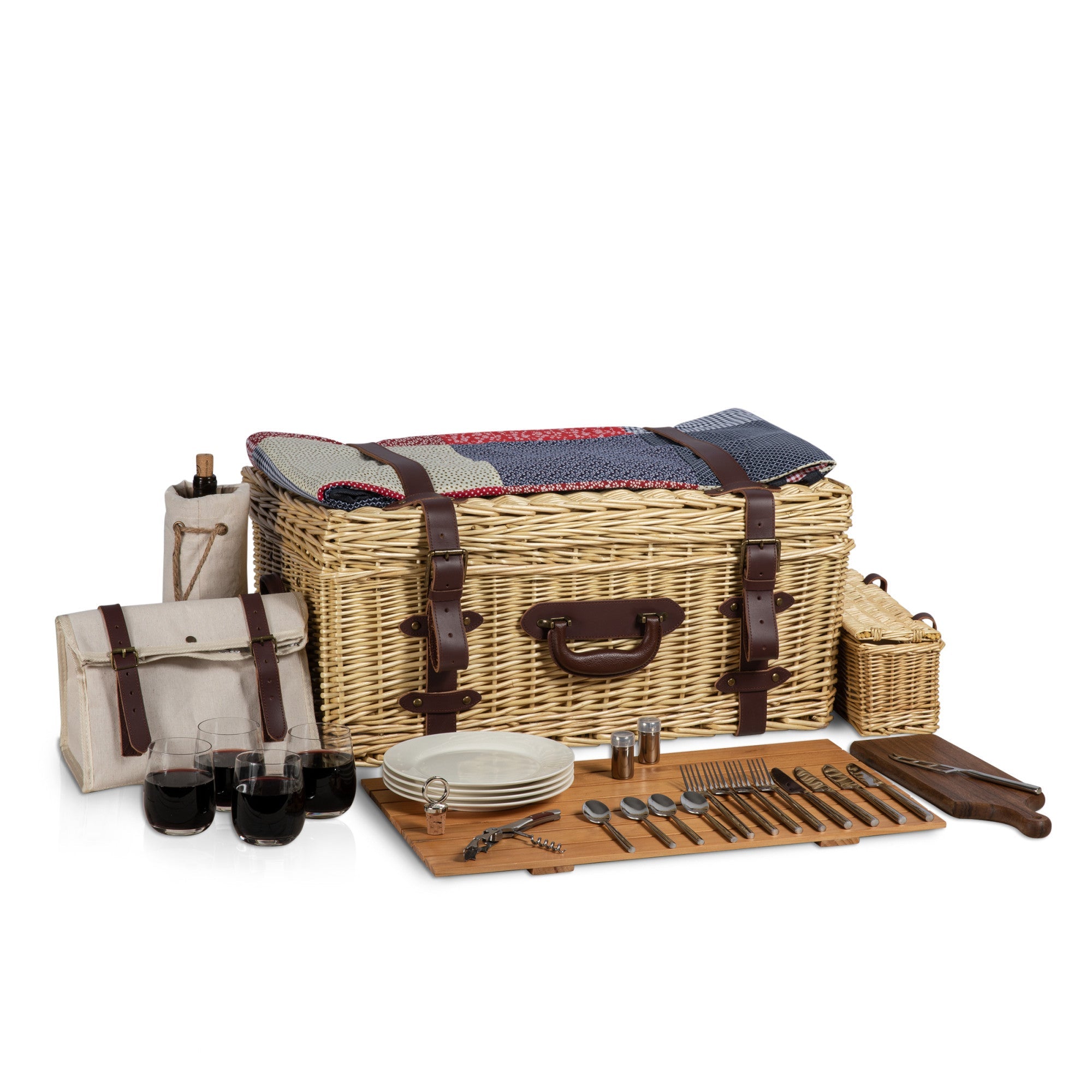 Wicker picnic basket with cutlery, plates, and glasses on a white background